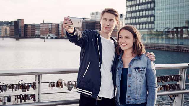 Young couple taking a selfie in the city.