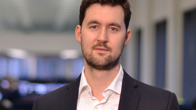 Ungt par som sitter i sofaen med PC.